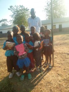 Vulnerable children of Otuke Central Primary school happy after receiving books and pencil they will use this term